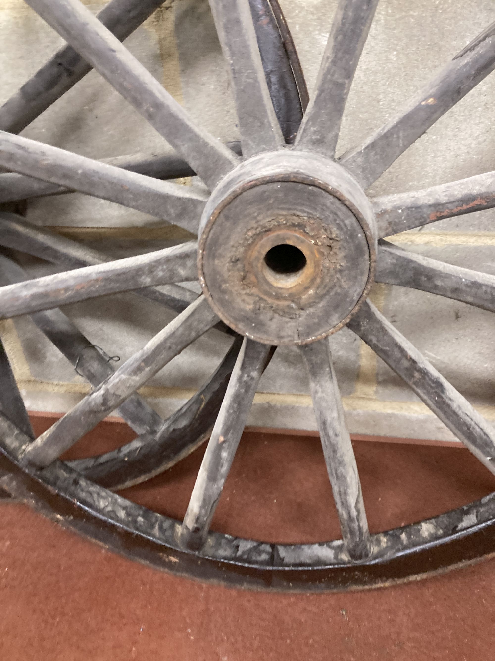 A pair of Victorian iron mounted spoked cart wheels, 70cm diameter
